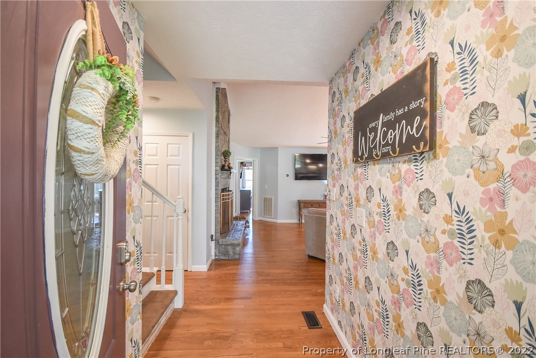 102 Chesapeake Road Cameron, NC 28326 - Photo 4 of 50 a view of entryway with furniture and wooden floor