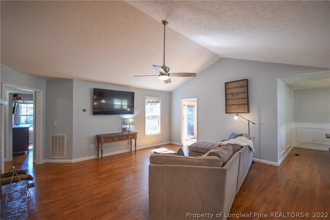 102 Chesapeake Road Cameron, NC 28326 - Photo 5 of 50 a living room with furniture a flat screen tv and wooden floor