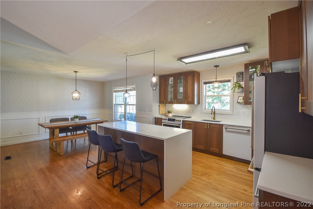102 Chesapeake Road Cameron, NC 28326 - Photo 10 of 50 a kitchen with a dining table chairs and refrigerator