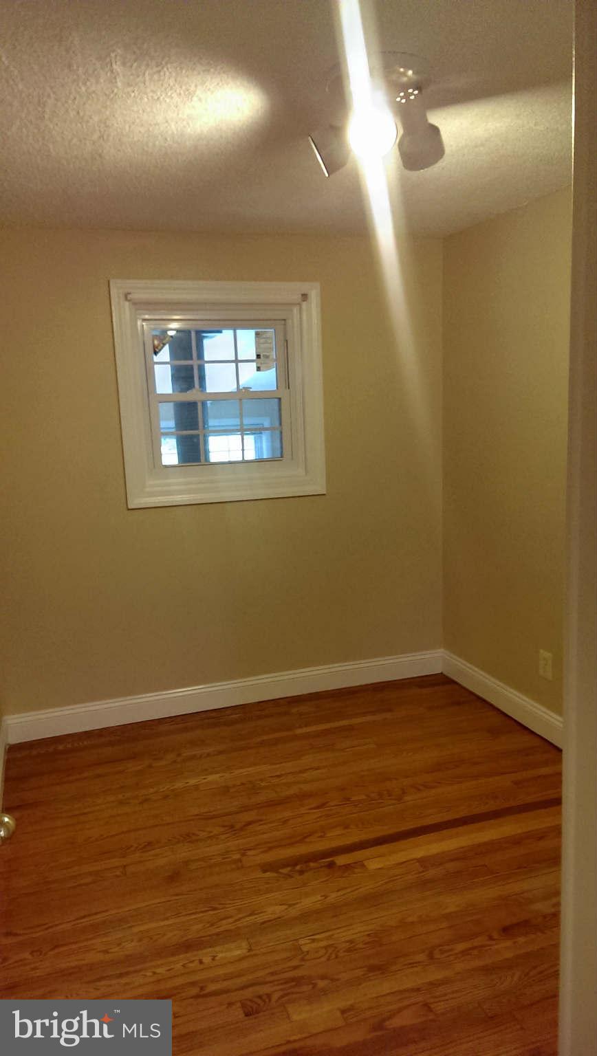 12102 Foley Street Silver Spring, MD 20902 - Photo 16 of 29 a view of an empty room with wooden floor and a window