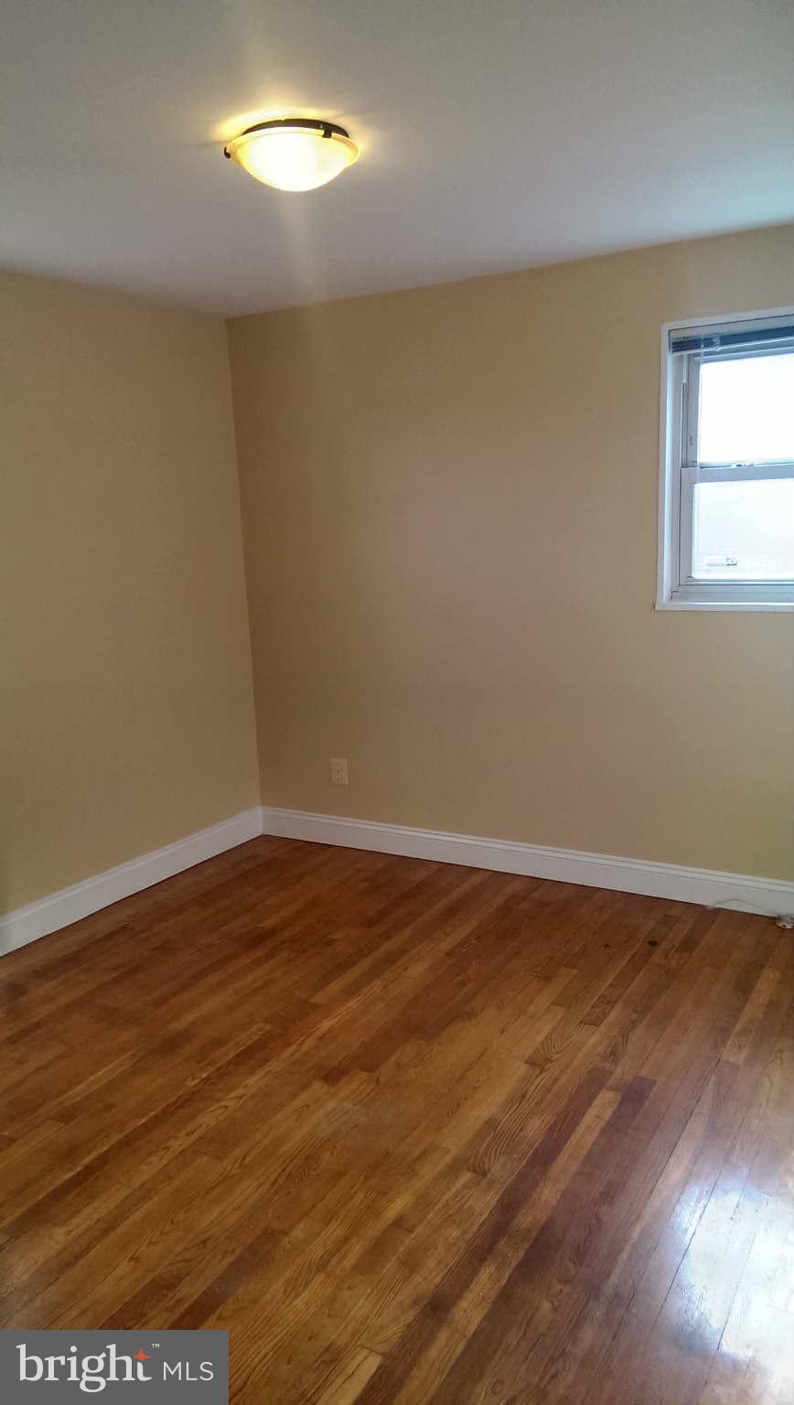 12102 Foley Street Silver Spring, MD 20902 - Photo 17 of 29 a view of an empty room with wooden floor and a window