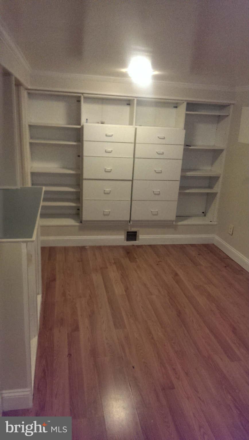 12102 Foley Street Silver Spring, MD 20902 - Photo 23 of 29 a view of walk in closet with empty racks