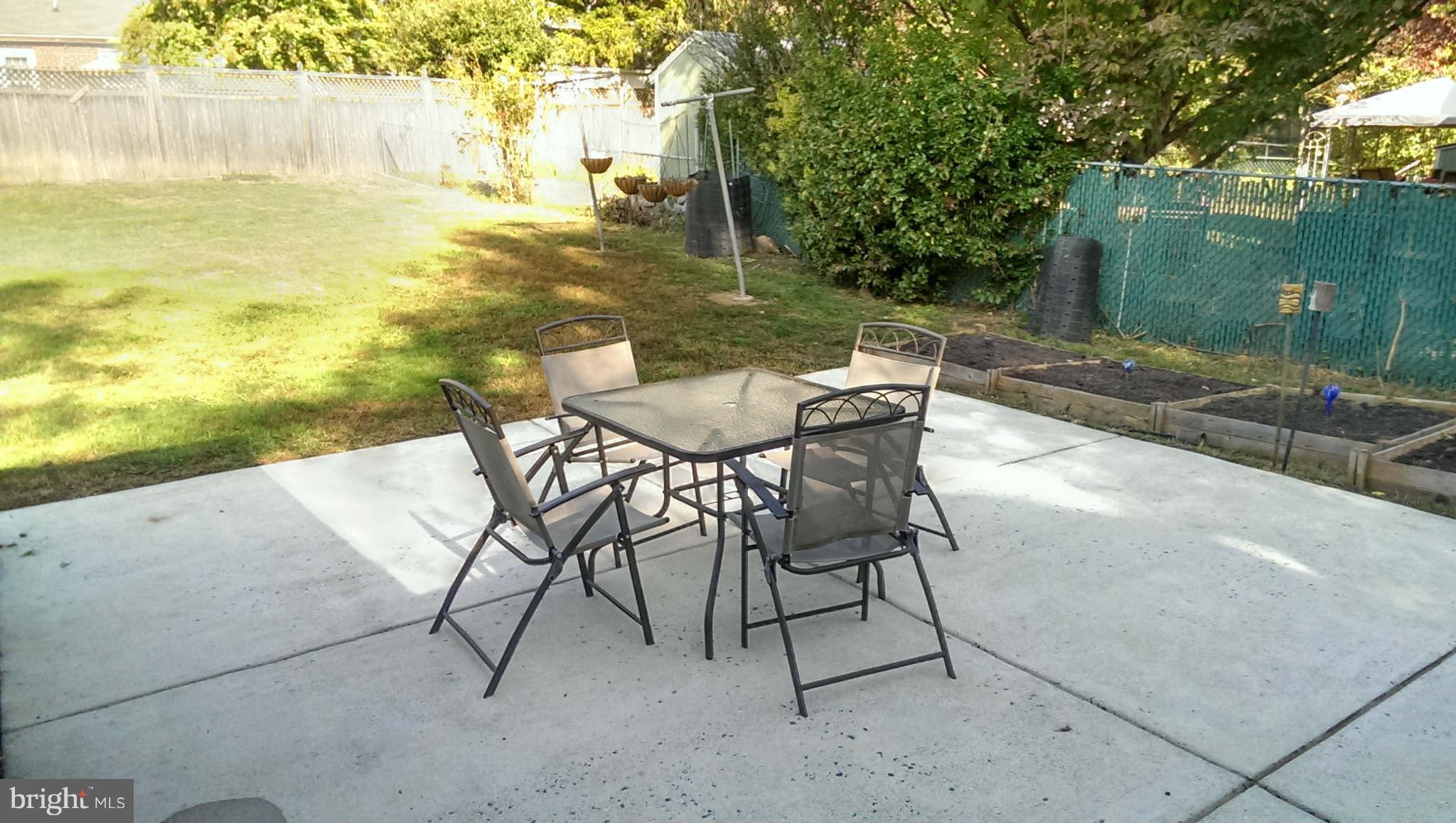 12102 Foley Street Silver Spring, MD 20902 - Photo 26 of 29 a backyard of a house with table and chairs