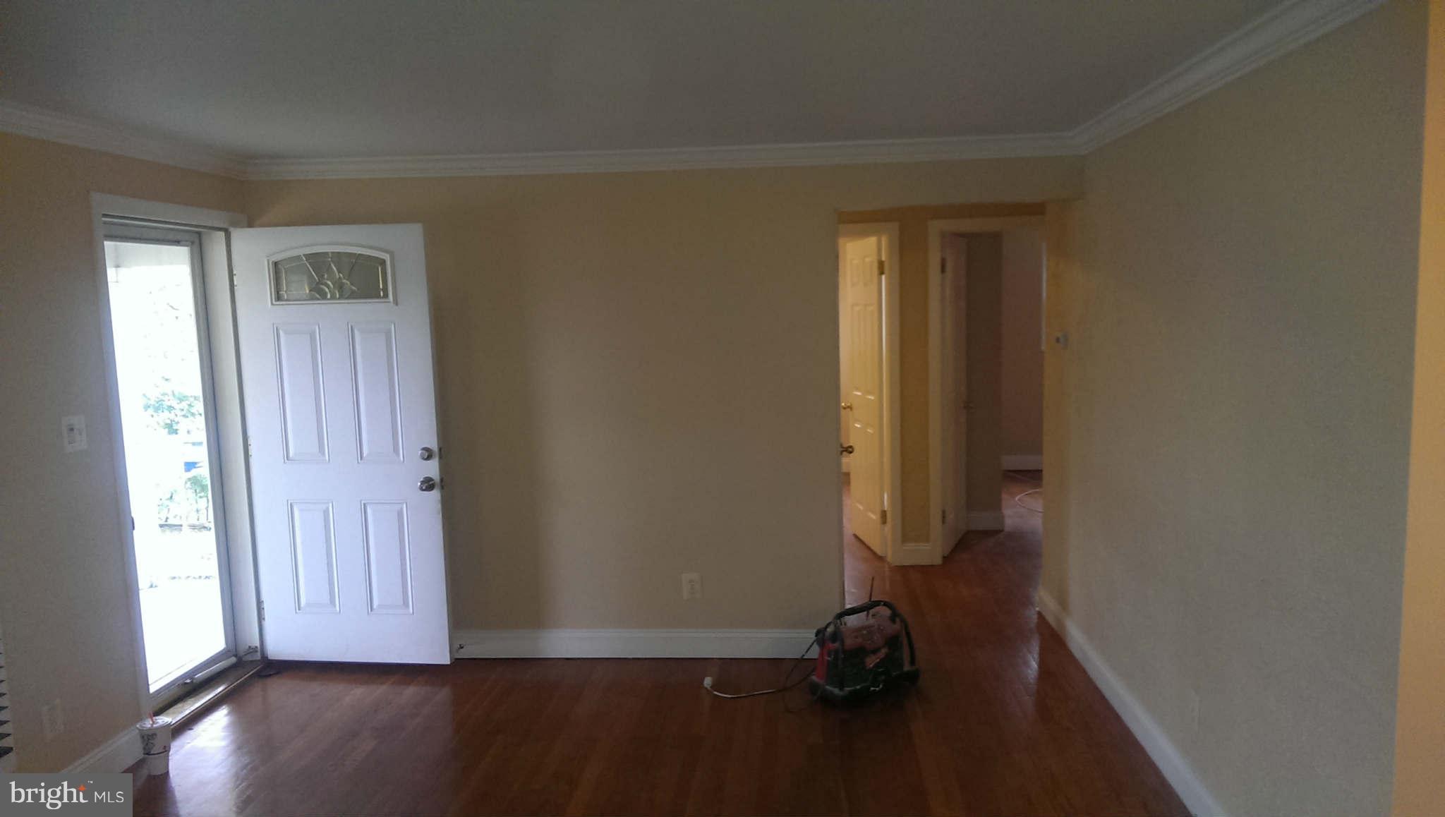 12102 Foley Street Silver Spring, MD 20902 - Photo 6 of 29 an empty room with wooden floor and windows