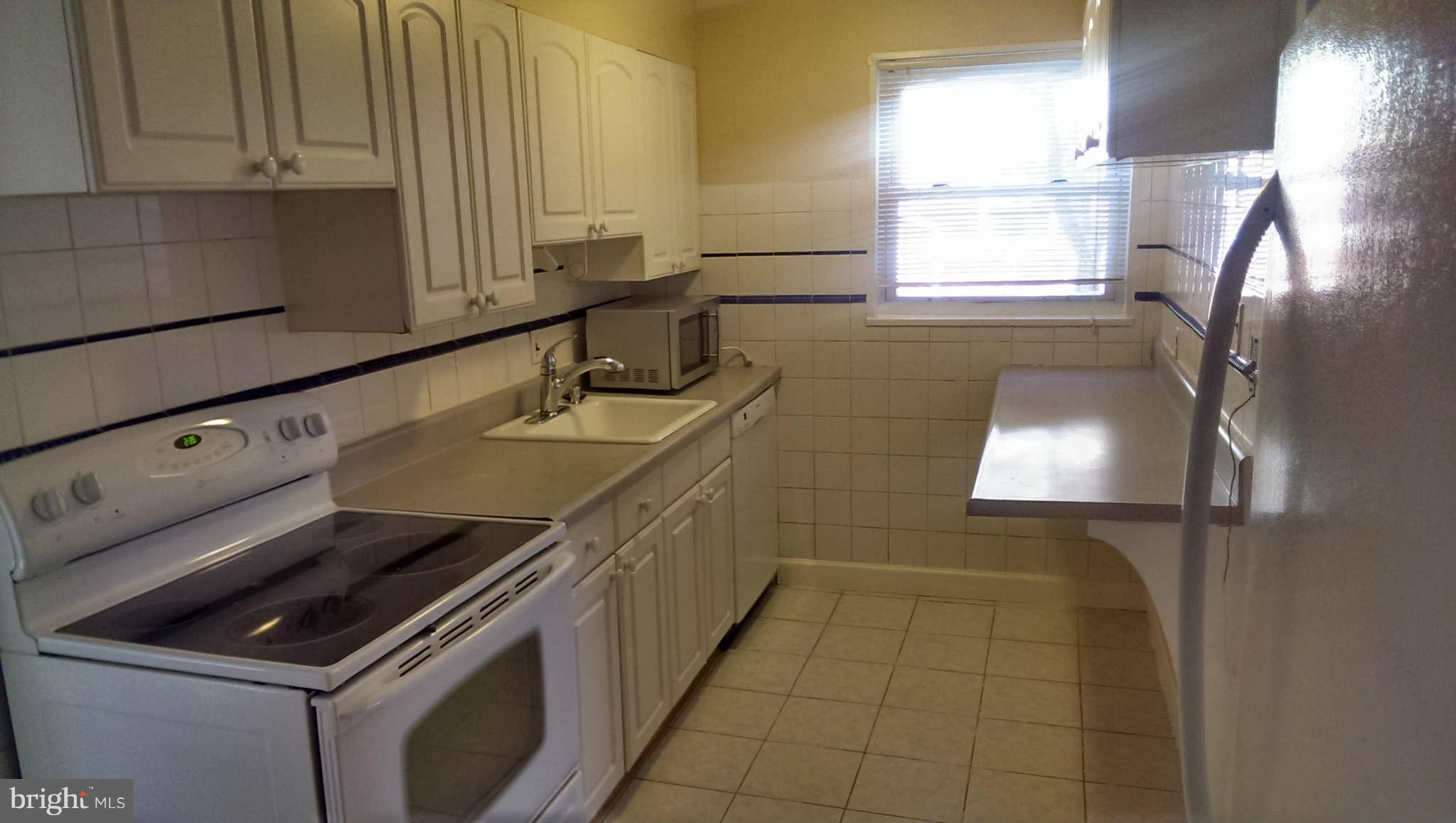 12102 Foley Street Silver Spring, MD 20902 - Photo 10 of 29 a kitchen that has a sink and a stove