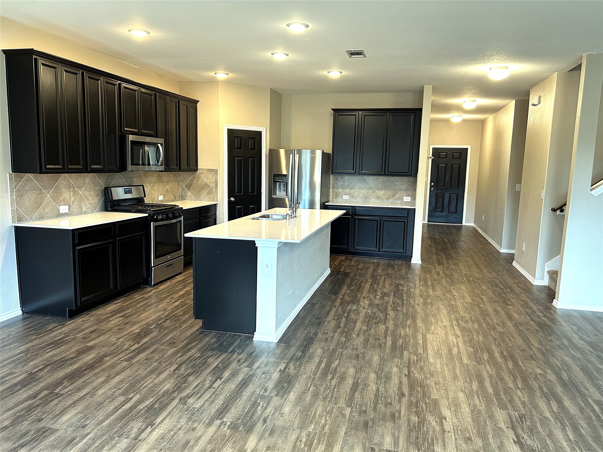 2363 Timberland Country Drive Conroe, TX 77304 - Photo 4 of 25 Long view of kitchen and entry hall, LVP flooring