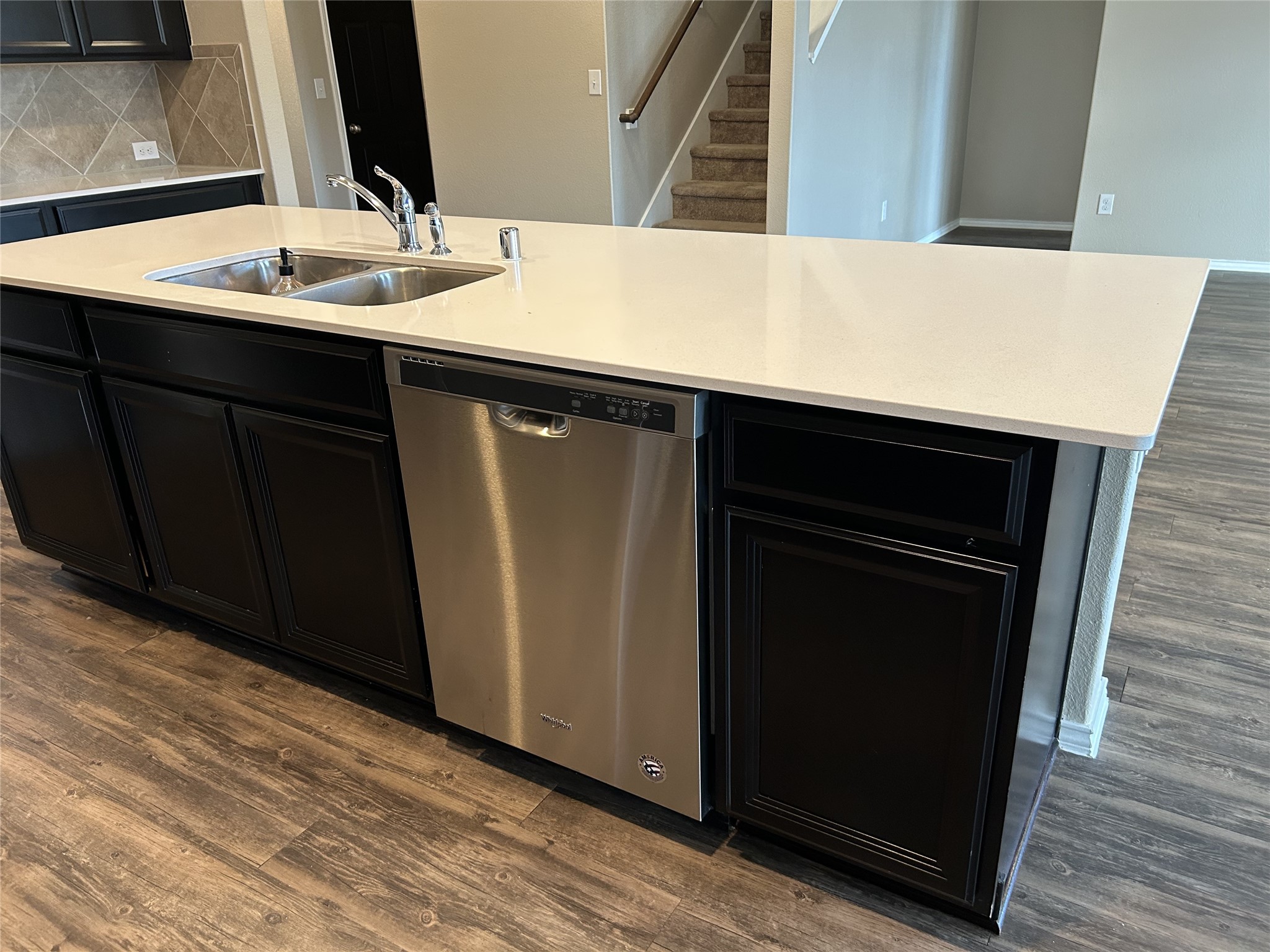 2363 Timberland Country Drive Conroe, TX 77304 - Photo 7 of 25 A view of the quartz countertop with dishwasher and divided sink
