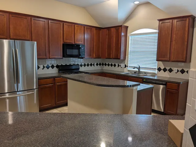 a kitchen with a sink stove and refrigerator