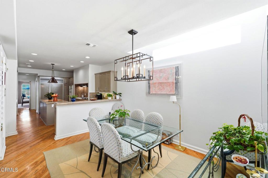 2317 Canyonback Road Los Angeles, CA 90049 - Photo 19 of 72 a dining room with furniture a chandelier and wooden floor