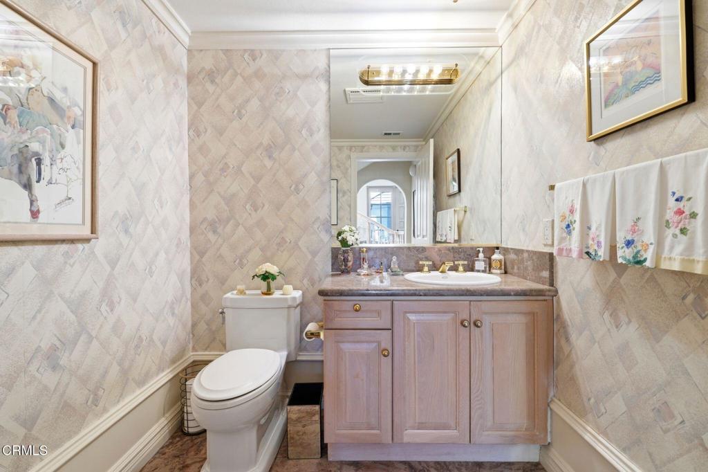 2317 Canyonback Road Los Angeles, CA 90049 - Photo 26 of 72 a bathroom with a granite countertop toilet sink and mirror