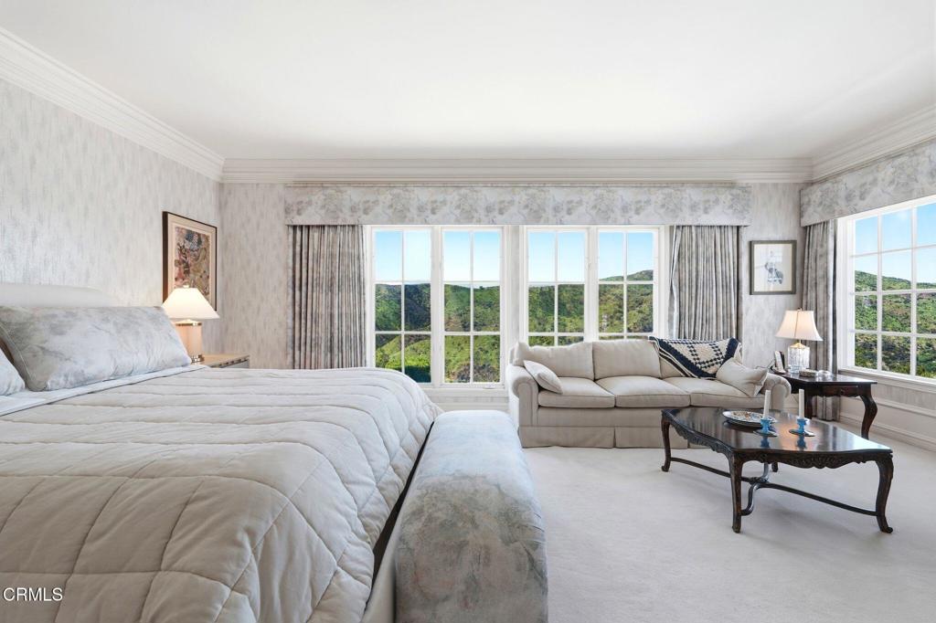 2317 Canyonback Road Los Angeles, CA 90049 - Photo 29 of 72 a spacious bedroom with a bed and a large window