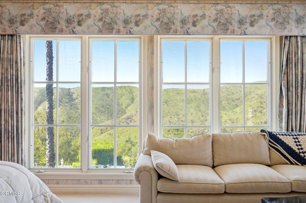 2317 Canyonback Road Los Angeles, CA 90049 - Photo 31 of 72 a living room with furniture and a large window