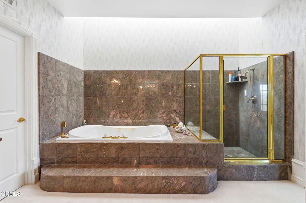 2317 Canyonback Road Los Angeles, CA 90049 - Photo 34 of 72 a living room with a couch and a shower