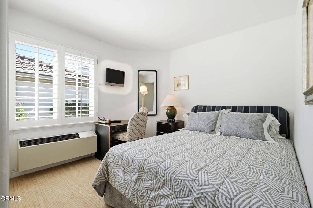 2317 Canyonback Road Los Angeles, CA 90049 - Photo 40 of 72 a bedroom with a large bed and a window