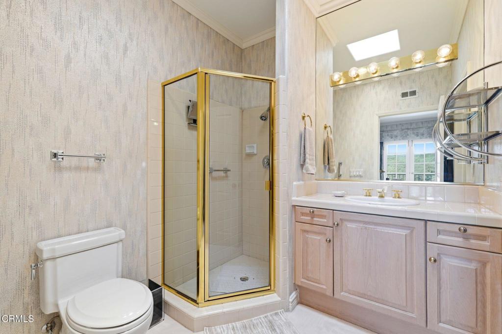2317 Canyonback Road Los Angeles, CA 90049 - Photo 41 of 72 a bathroom with a granite countertop sink toilet and shower