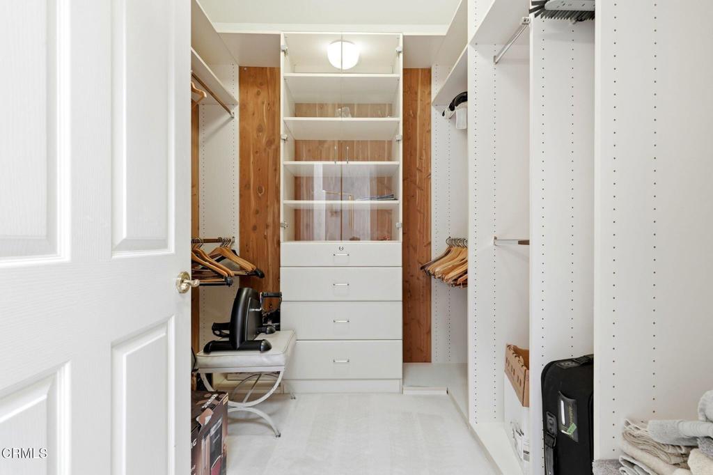 2317 Canyonback Road Los Angeles, CA 90049 - Photo 45 of 72 a view of walk in closet with clothes and shoes