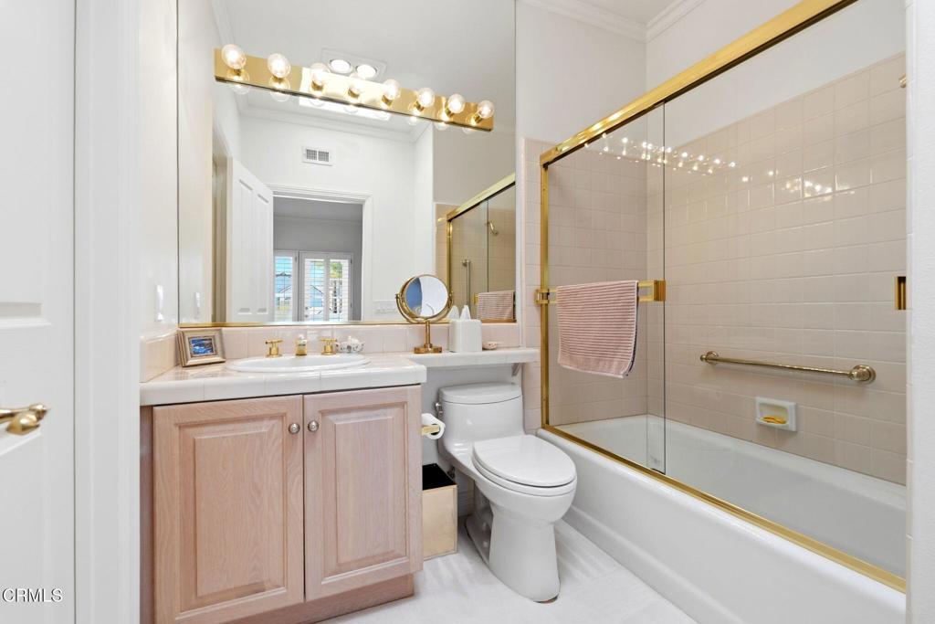 2317 Canyonback Road Los Angeles, CA 90049 - Photo 47 of 72 a bathroom with a toilet sink and a mirror
