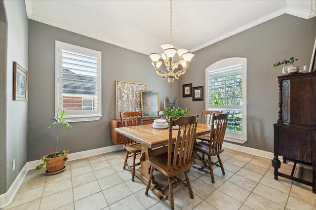 a view of a dining room with furniture and chandelier