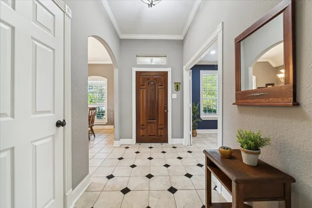 a view of a hallway with wooden floor and a mirror