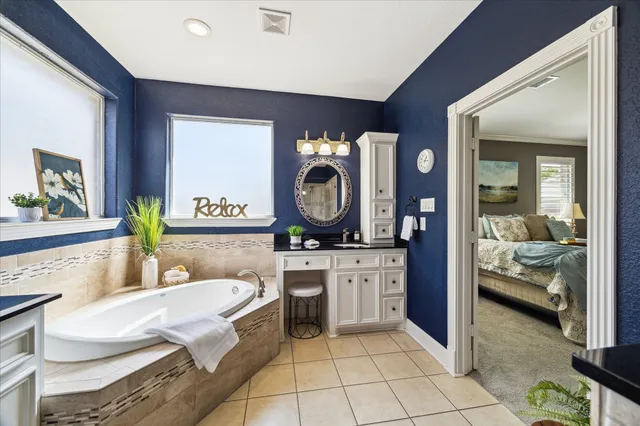 a living room with furniture a clock and a view of bathroom
