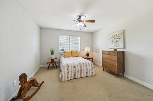 a bedroom with bed and a chandelier
