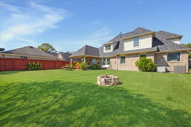 a front view of a house with a yard table and trees