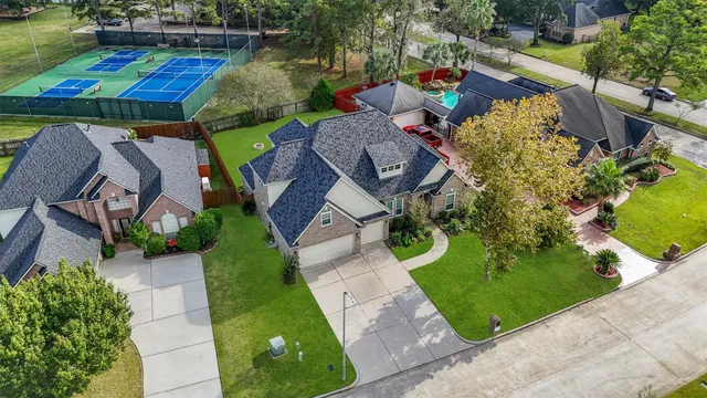 a aerial view of a house with swimming pool garden and patio