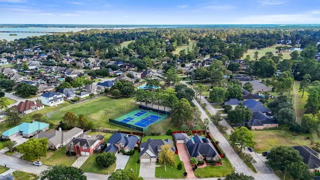 an aerial view of residential houses with outdoor space and street view