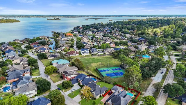 an aerial view of lake and residential houses with outdoor space