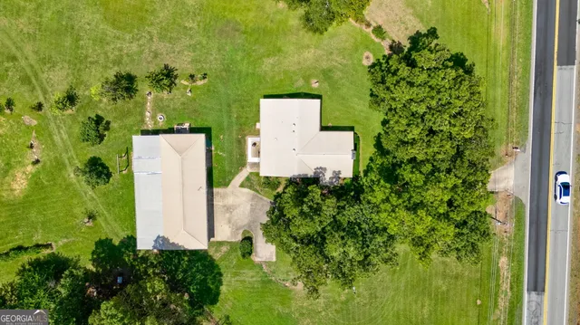 an aerial view of a house with a yard