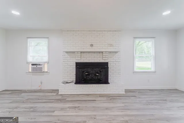a living room with a fireplace and a fireplace