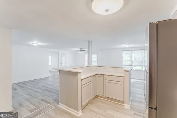 a kitchen with white cabinets and sink