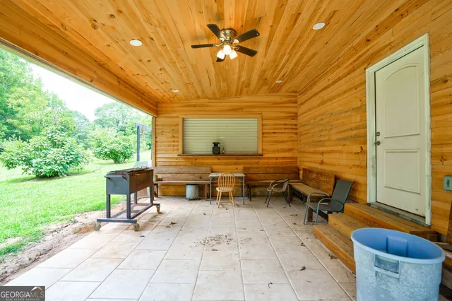 a view of green field with trees in the background