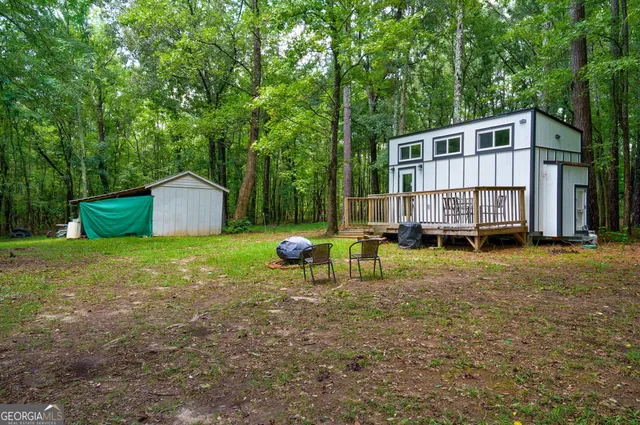 a view of yard with swimming pool and green space