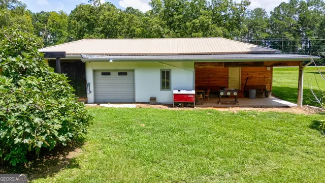 a view of a chair and table in the backyard of the house
