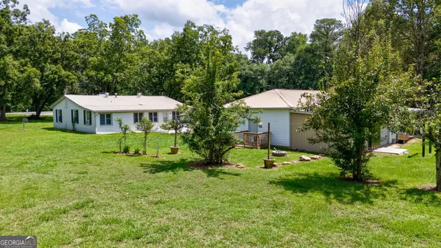 a backyard of a house with table and chairs