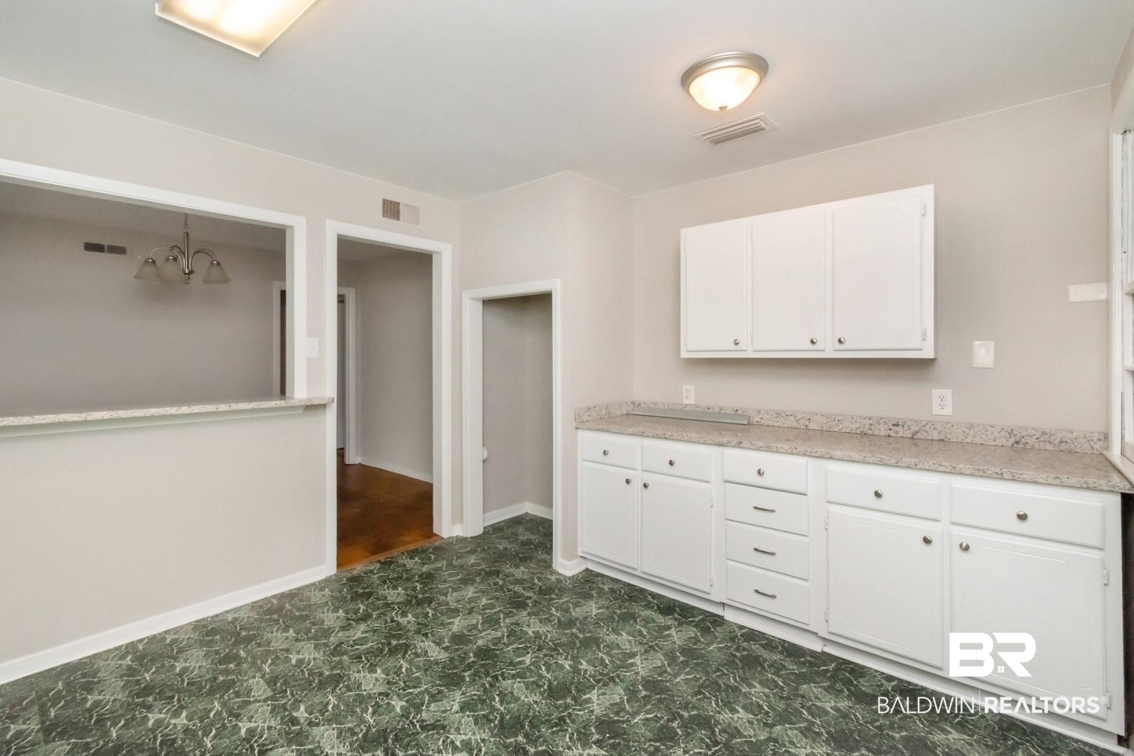 1220 Garland Drive Mobile, AL 36618 - Photo 11 of 25 Kitchen with dark tile patterned flooring and white cabinets