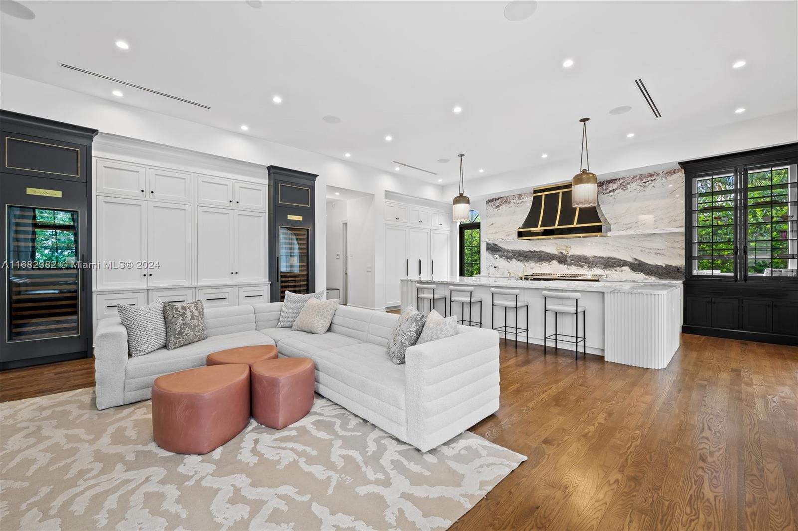 406 Tamarind Drive Hallandale Beach, FL 33009 - Photo 12 of 37 a large living room with stainless steel appliances kitchen island granite countertop a couch and a view of living room