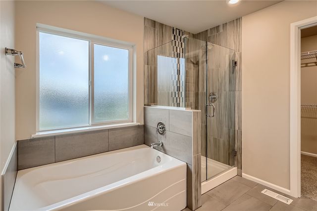 a bathroom with a tub and a shower