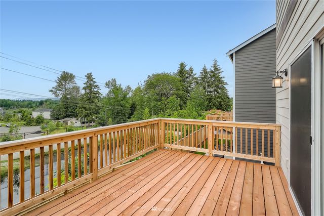 a view of balcony with wooden floor and fence