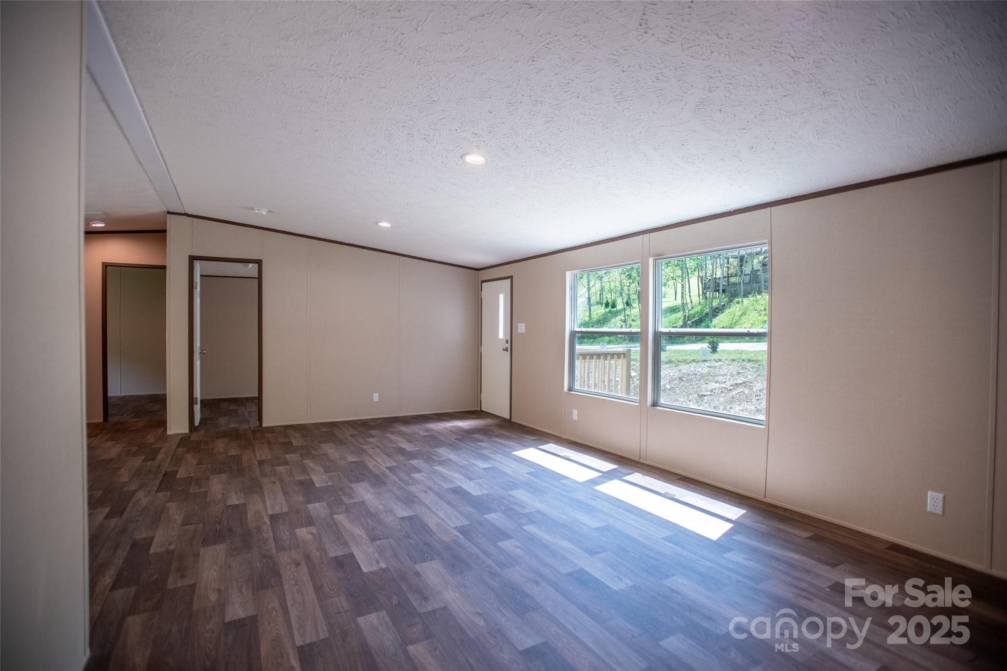 1455 Newfound Road Leicester, NC 28748 - Photo 12 of 47 a view of an empty room with wooden floor and a window