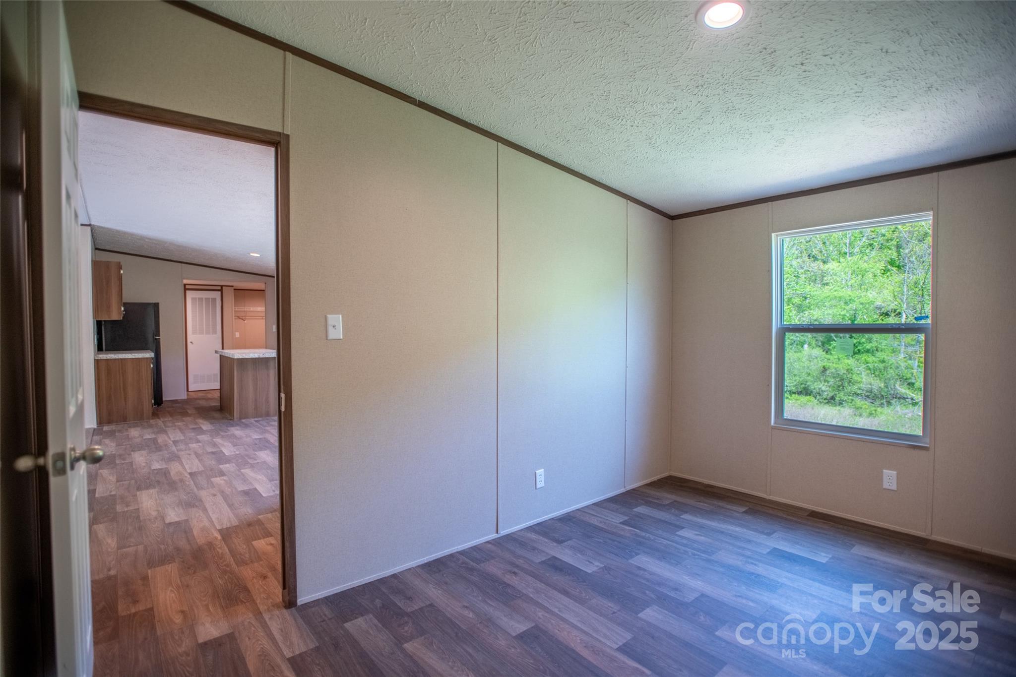 1455 Newfound Road Leicester, NC 28748 - Photo 19 of 47 an empty room with wooden floor and a window