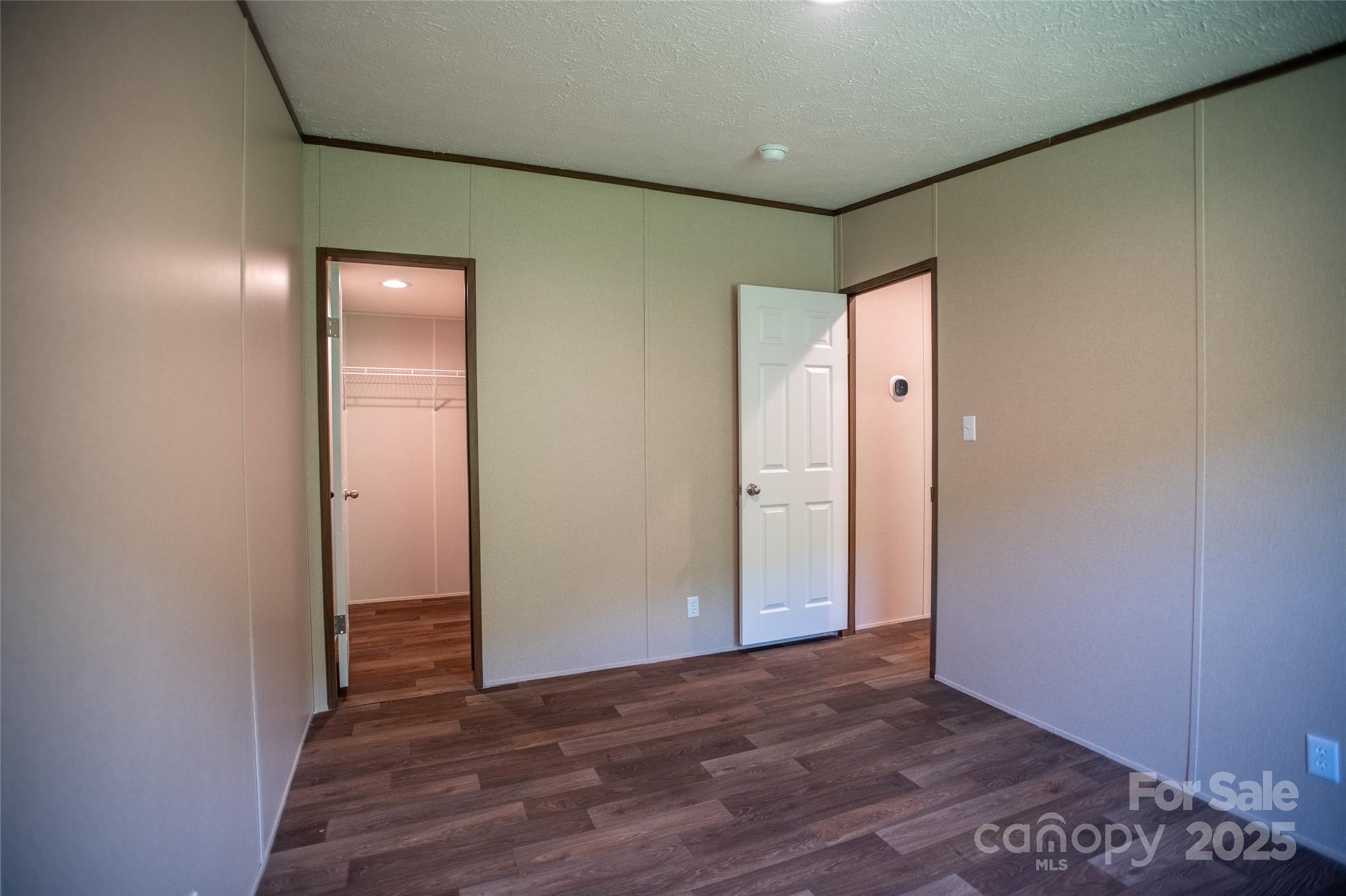 1455 Newfound Road Leicester, NC 28748 - Photo 20 of 47 an empty room with wooden floor and windows