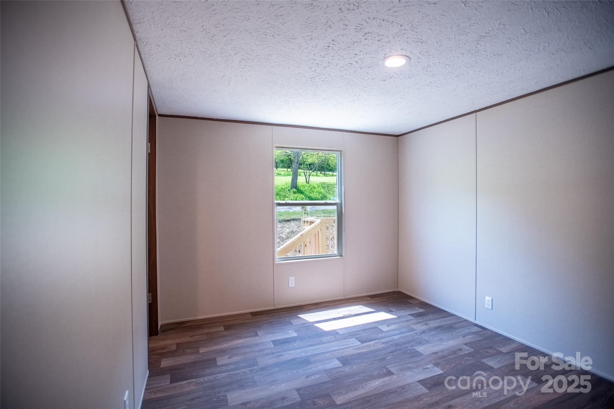 1455 Newfound Road Leicester, NC 28748 - Photo 22 of 47 an empty room with wooden floor and window