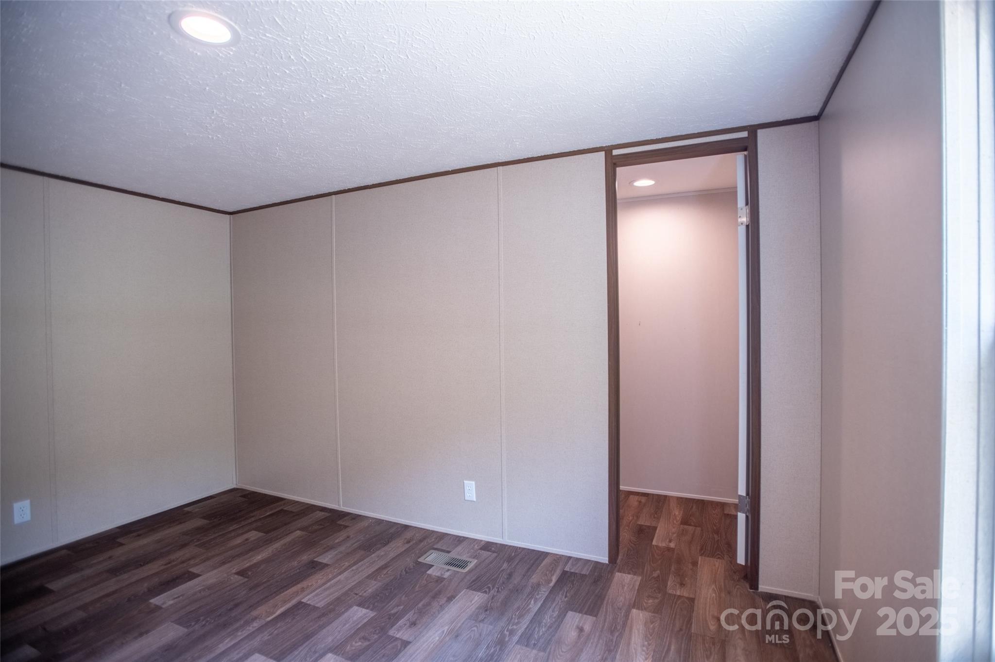 1455 Newfound Road Leicester, NC 28748 - Photo 23 of 47 a view of an empty room with wooden floor and closet