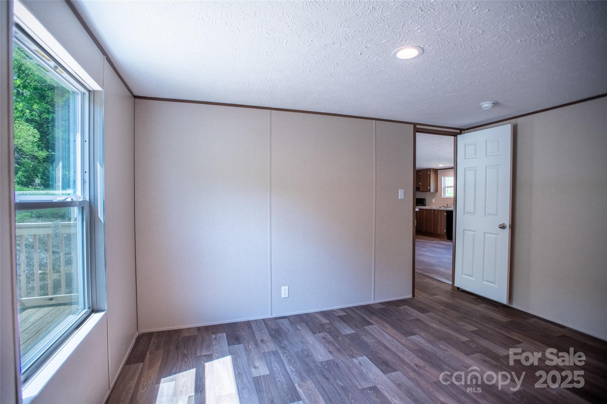 1455 Newfound Road Leicester, NC 28748 - Photo 24 of 47 a view of empty room with wooden floor and fan