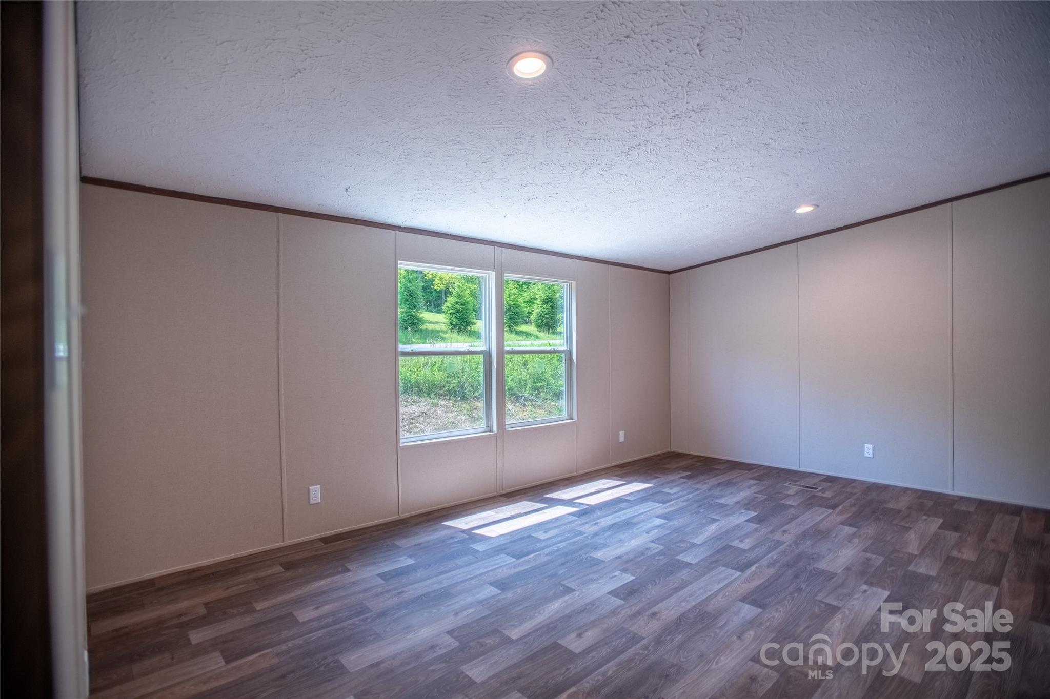 1455 Newfound Road Leicester, NC 28748 - Photo 25 of 47 an empty room with wooden floor and windows