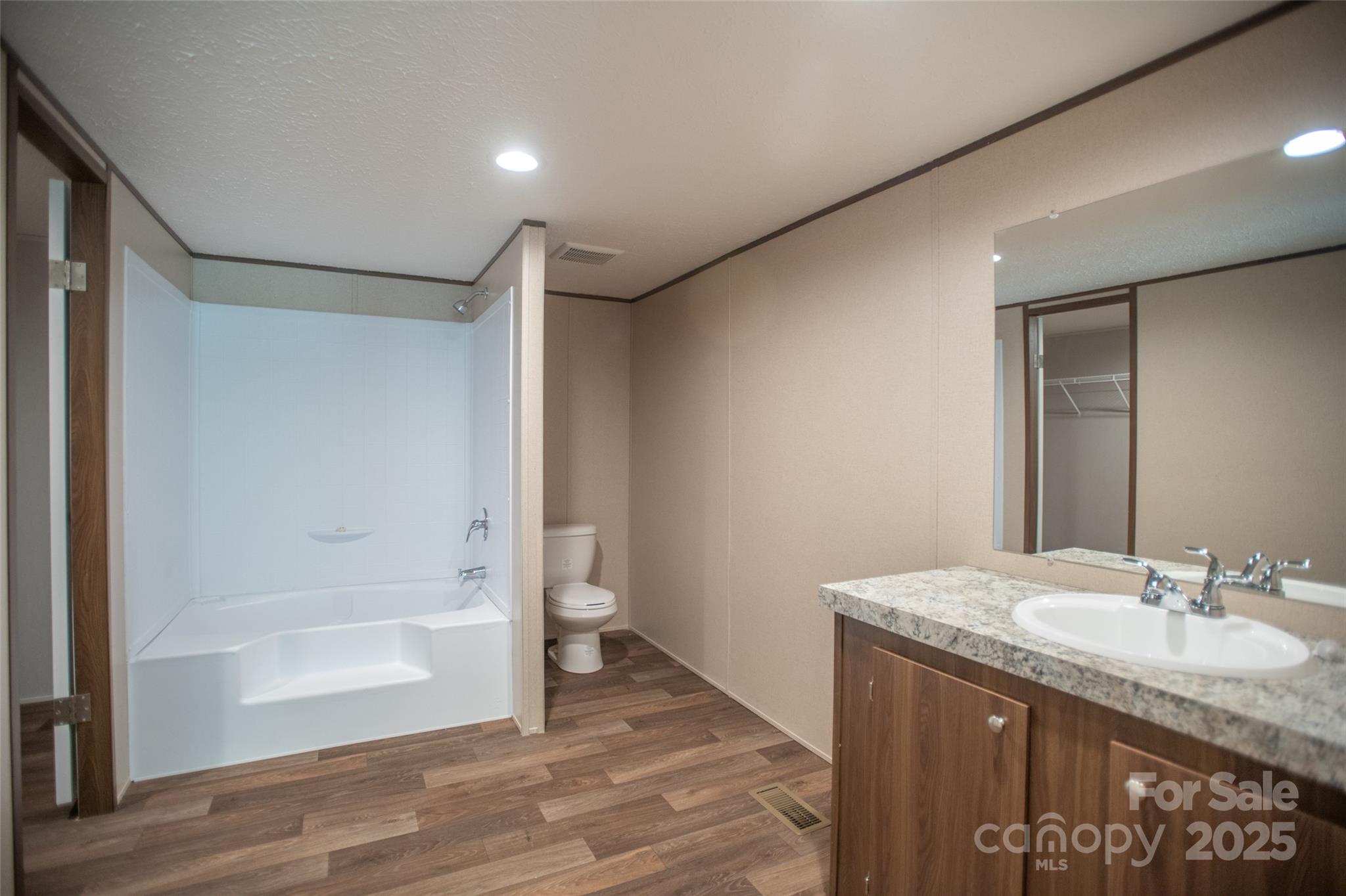 1455 Newfound Road Leicester, NC 28748 - Photo 26 of 47 a bathroom with a granite countertop sink a toilet and shower