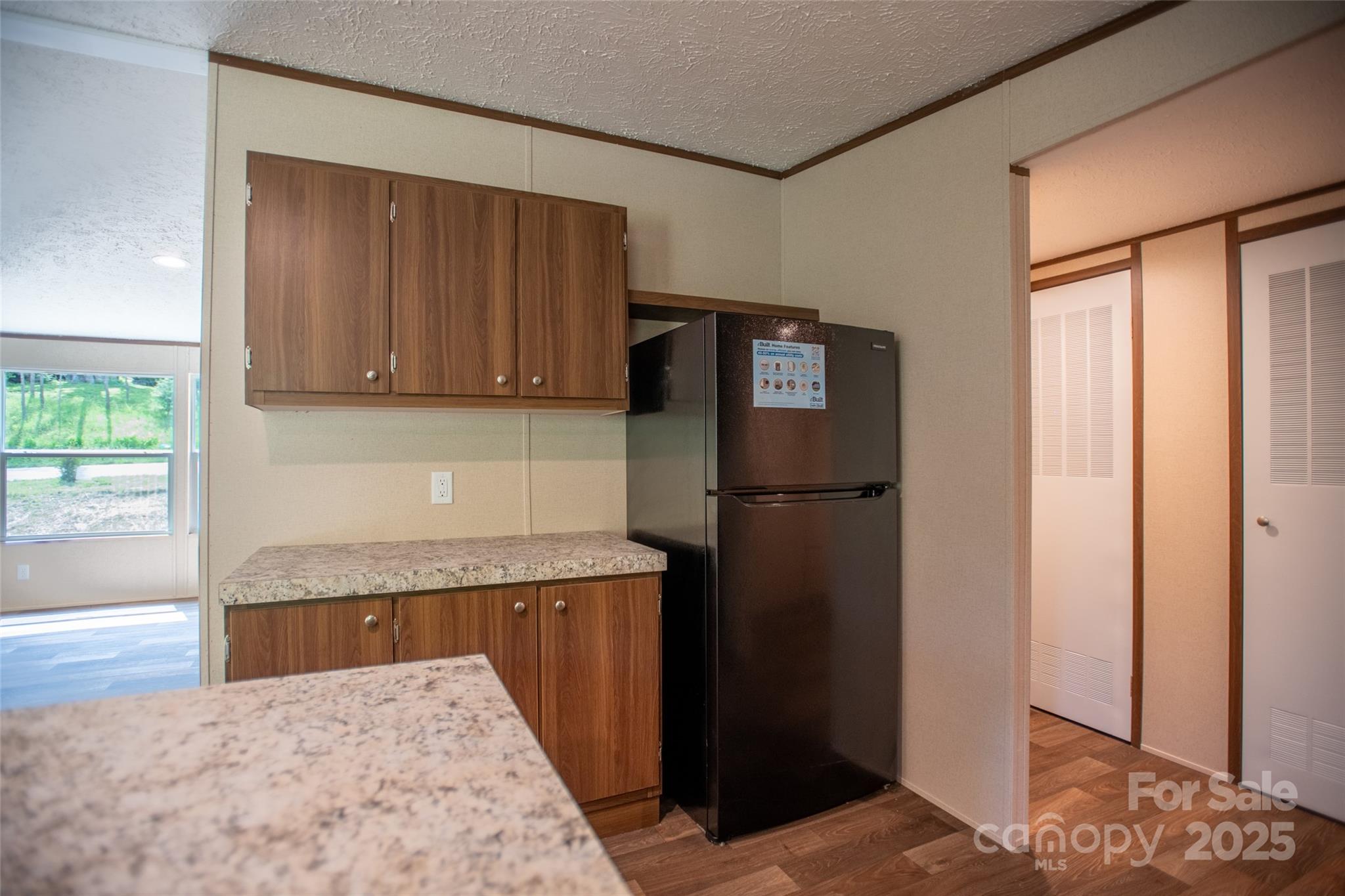 1455 Newfound Road Leicester, NC 28748 - Photo 5 of 47 a kitchen with a refrigerator and cabinets