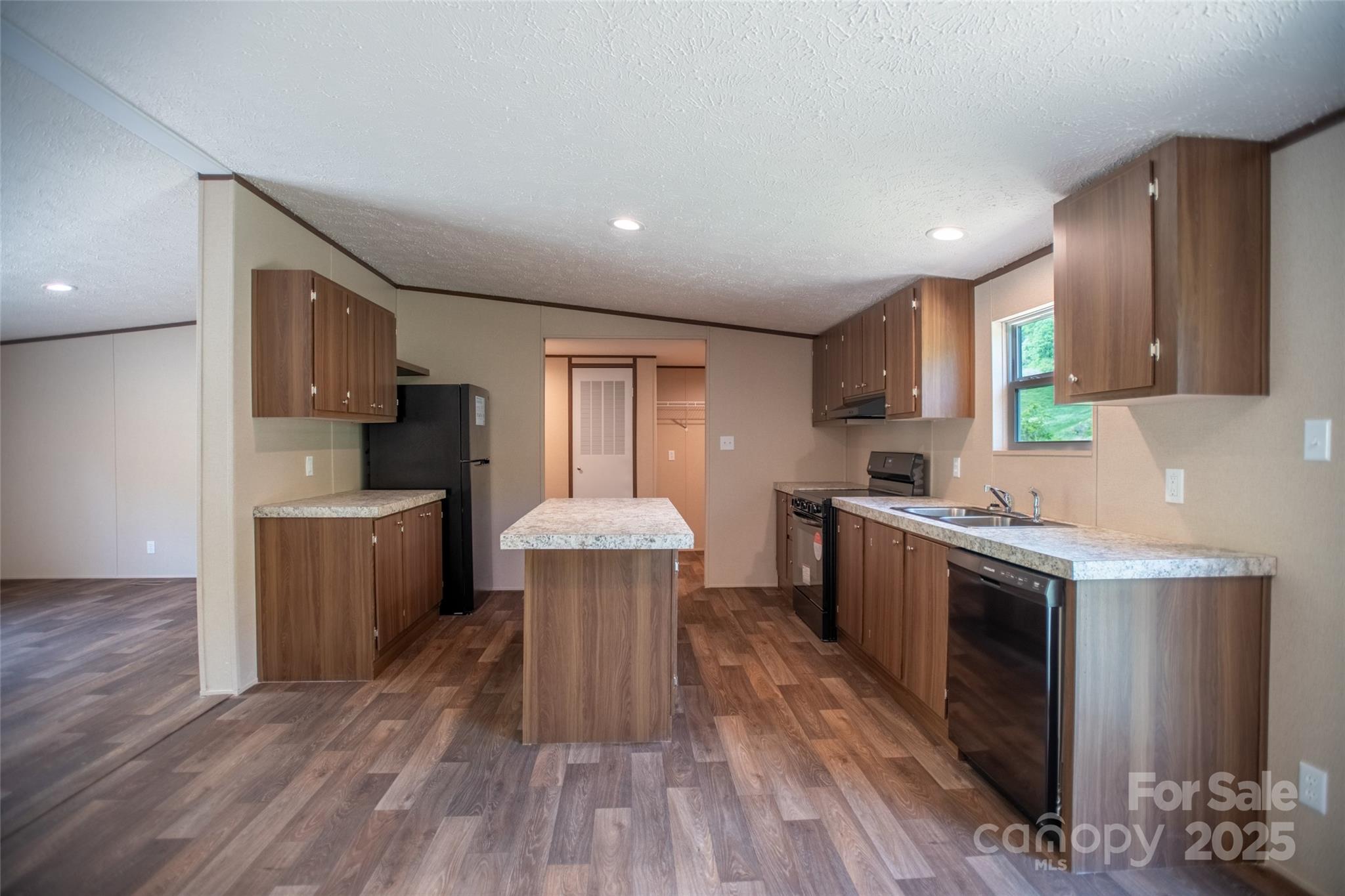 1455 Newfound Road Leicester, NC 28748 - Photo 7 of 47 a kitchen with a stove a refrigerator and a sink with wooden floor